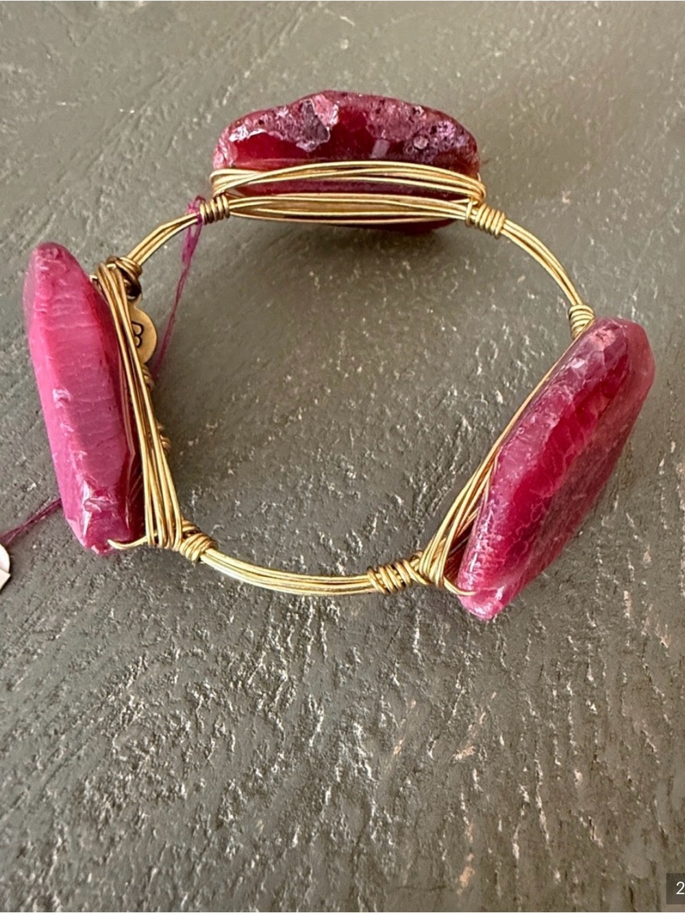 Two pink and gold bracelets